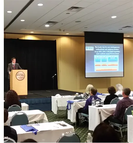 Founder addressing attendees at a seminar